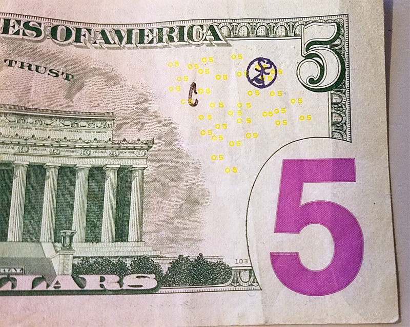 SSoIH logo stamped on a $5 note